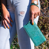 image of woman holding green cork wallet